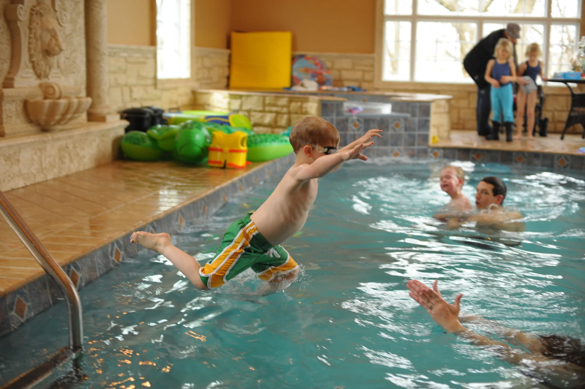 Jack Mahoney at age three jumping into a pool during a swim lesson